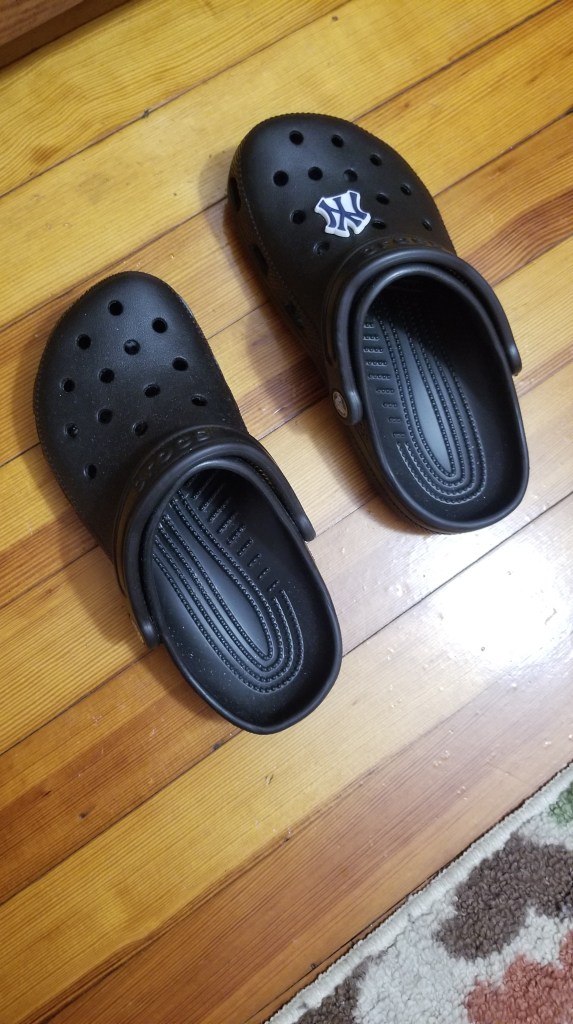 Photo description
Black crocks with a New York Yankees jibbit on one shoe
#summer #shoes #crocs 